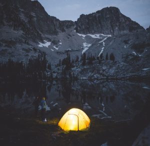 couple-setting-tent-by-mountain-lake-dawn