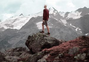 mountain-climber-standing-on-a-rock-snowy-mountain-view